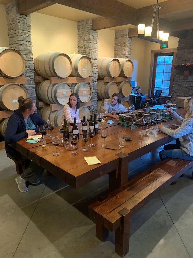 Guests seated at the farm table tasting wines during the Blending Table Experience at Silvara Cellars