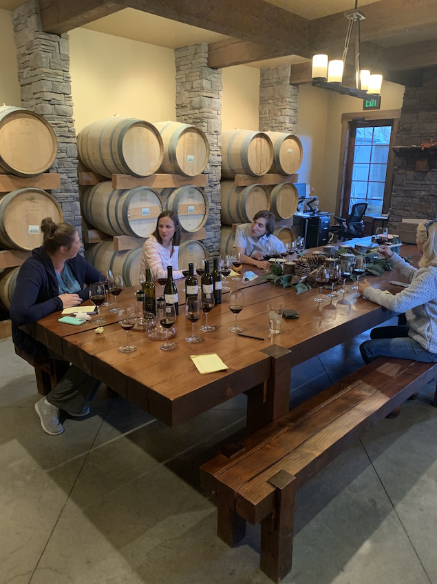 Guests seated at the farm table tasting wines during the Blending Table Experience at Silvara Cellars