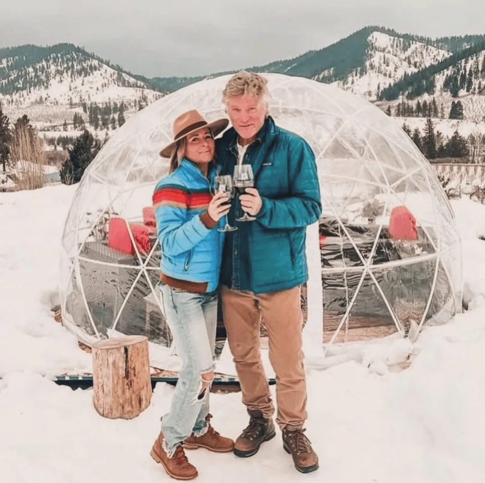 A couple standing outside an igloo dome at Silvara Cellars on a winter afternoon