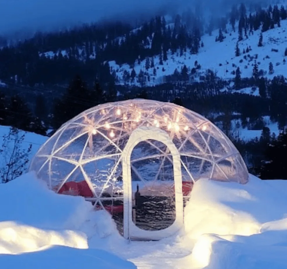 A single igloo dome lit from inside at night at Silvara Cellars