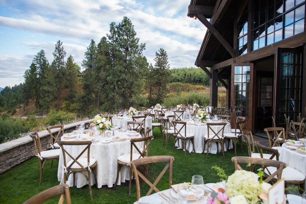 Wedding reception tables and chairs set up on the lawn at Silvara Cellars, with the winery entrance to the right