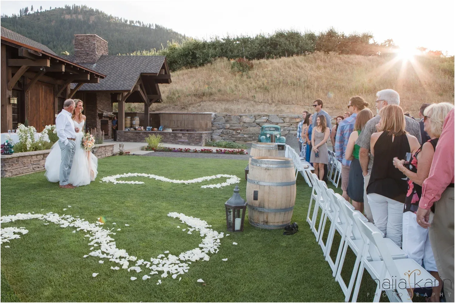Bride on the lawn at Silvara Cellars facing a group of guests, with the winery building behind them on the left